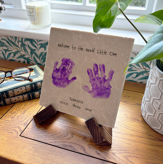 A bespoke medium marble picture tile featuring newborn handprints and measurements, a unique and meaningful gift for new parents.