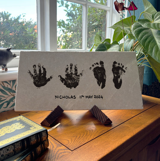 A cherished memories marble picture tile on a wooden stand, personalised with baby handprints and footprints. A timeless keepsake for grandparents and family members.