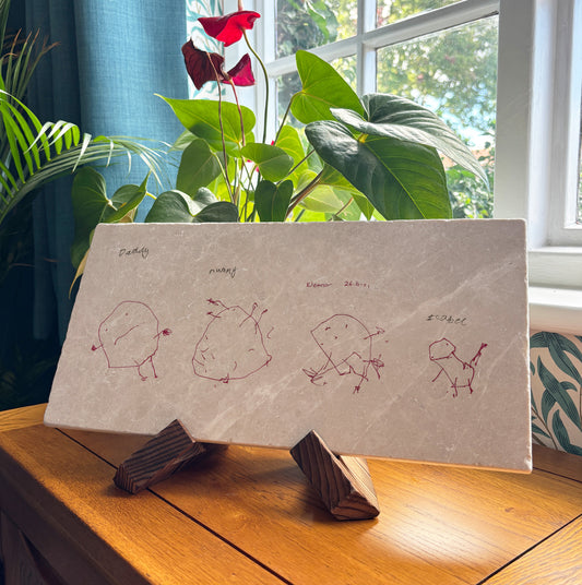 Unique marble tile displaying a child’s drawing of their family, a bespoke keepsake gift for grandparents and parents.