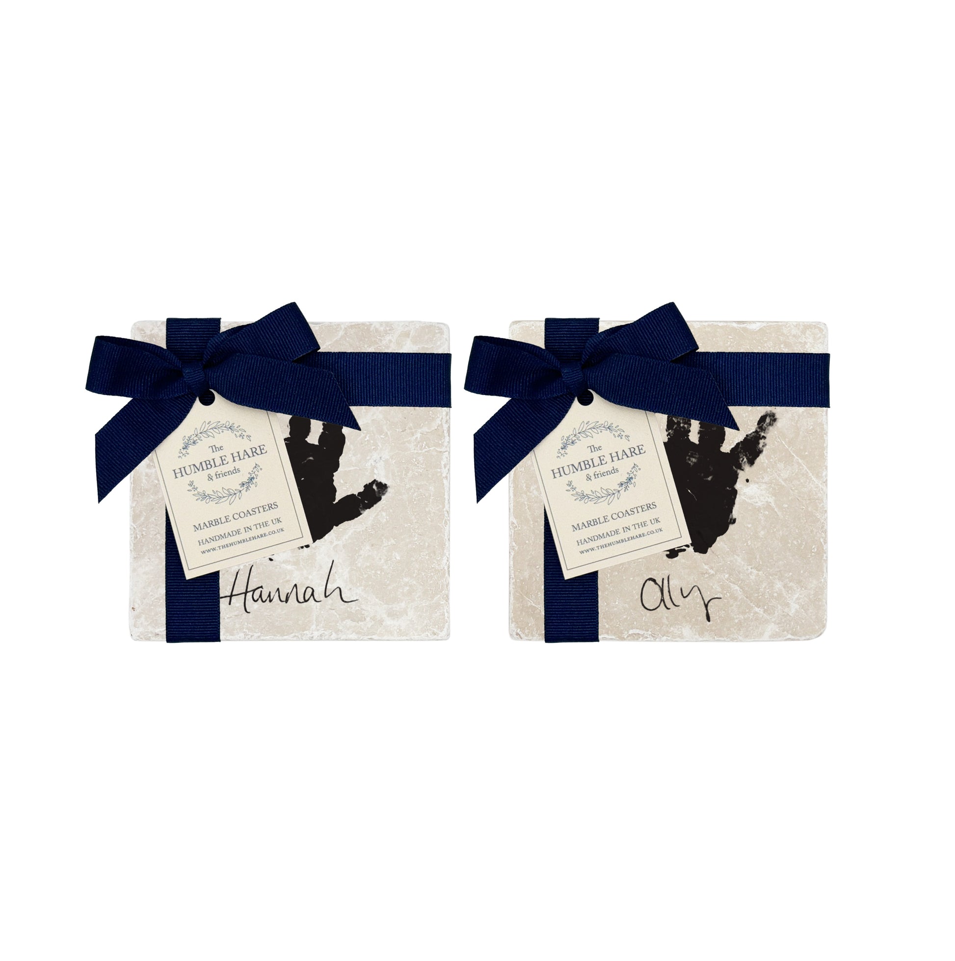 A personalised set of 4 marble coasters with baby's handprints and name, an ideal gift to celebrate a newborn, perfect gifts for new parents and grandparents. The coasters are packaged with luxurious blue bows.