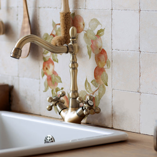 A rustic country kitchen sink with a large 30.5x30.5cm marble tile splash back featuring a watercolour apple wreath design.