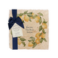 A personalised marble platter featuring a wreath of lemons and leaves, with a bespoke message in the centre of the design. The platter is packaged with a luxurious blue gift bow and tag.