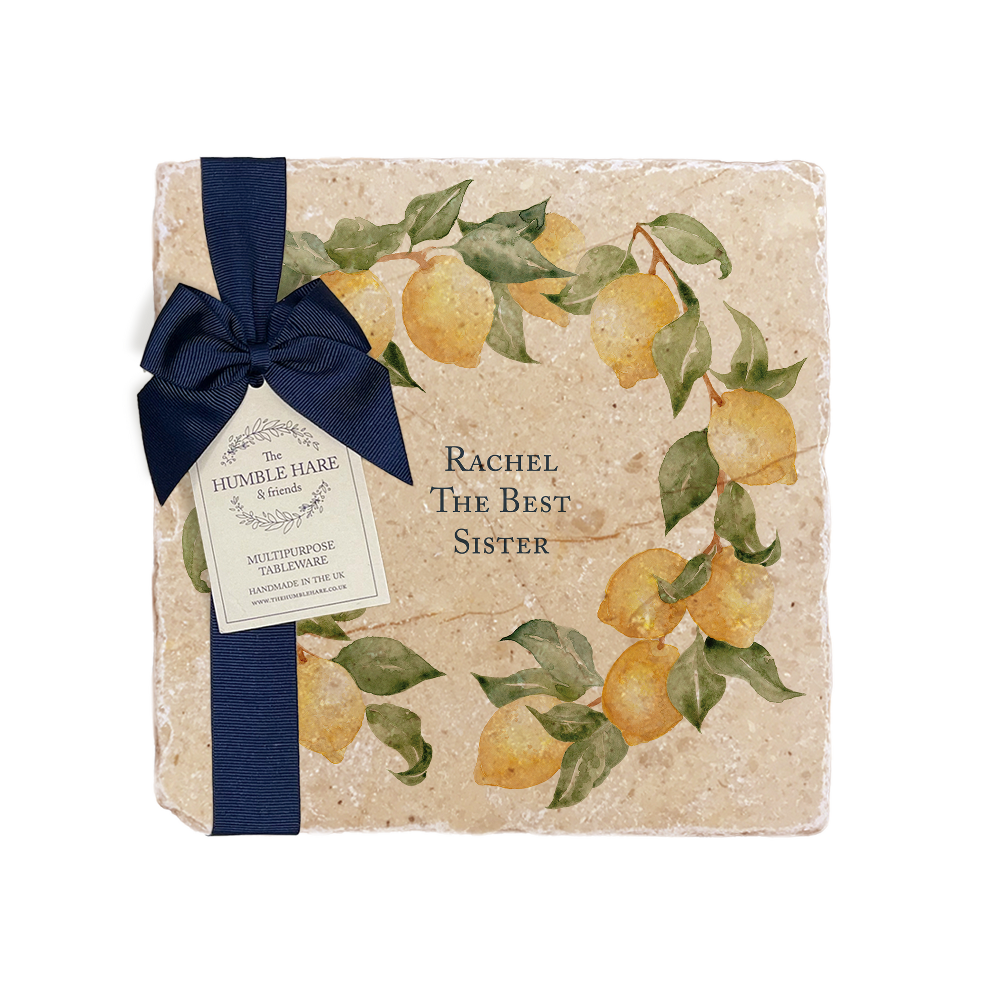 A personalised marble platter featuring a wreath of lemons and leaves, with a bespoke message in the centre of the design. The platter is packaged with a luxurious blue gift bow and tag.