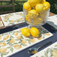 A garden table set with multipurpose marble platters ready for a dinner party. The platters feature a lemon pattern.