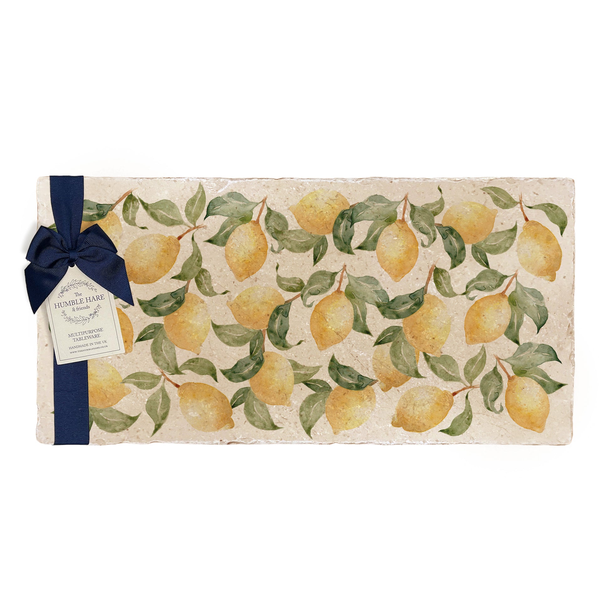 A multipurpose marble sharing platter with a watercolour lemon pattern, packaged with a luxurious dark blue bow and branded gift tag.