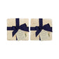 A set of 4 handmade marble coasters featuring a watercolour lemon design, packaged in 2 pairs, with a luxurious blue bow and gift tag.