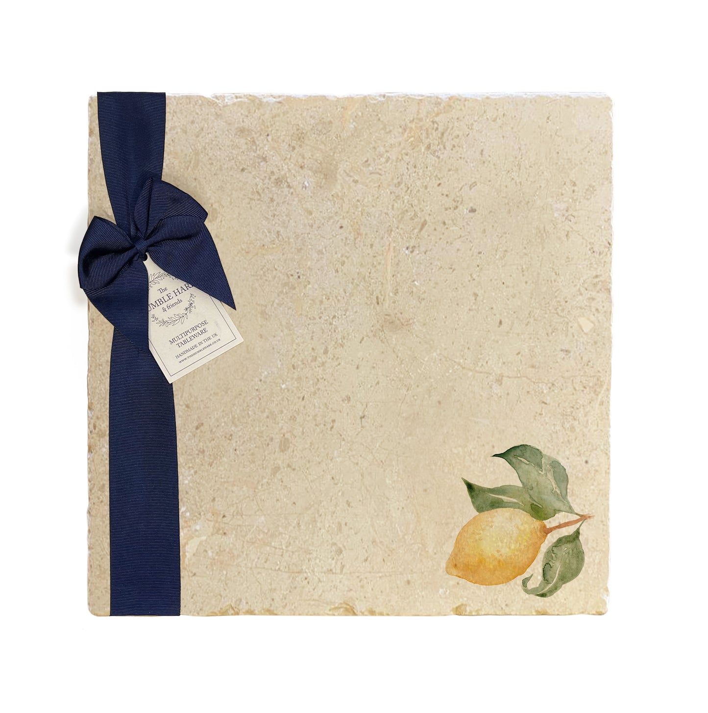 A large multipurpose marble platter with a watercolour minimalistic lemon design, packaged with a luxurious dark blue bow and branded gift tag.