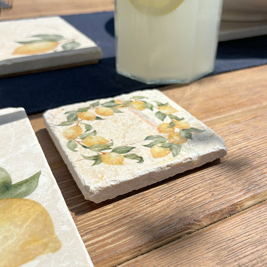 A square marble coaster featuring a watercolour wreath of lemon branches.