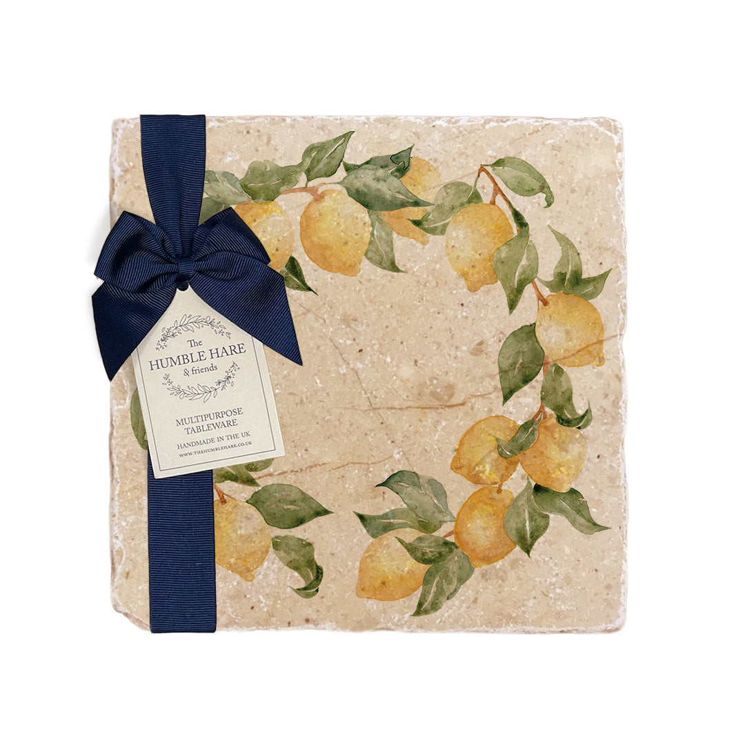 A medium multipurpose marble platter with a watercolour lemon wreath design, packaged with a luxurious dark blue bow and branded gift tag.