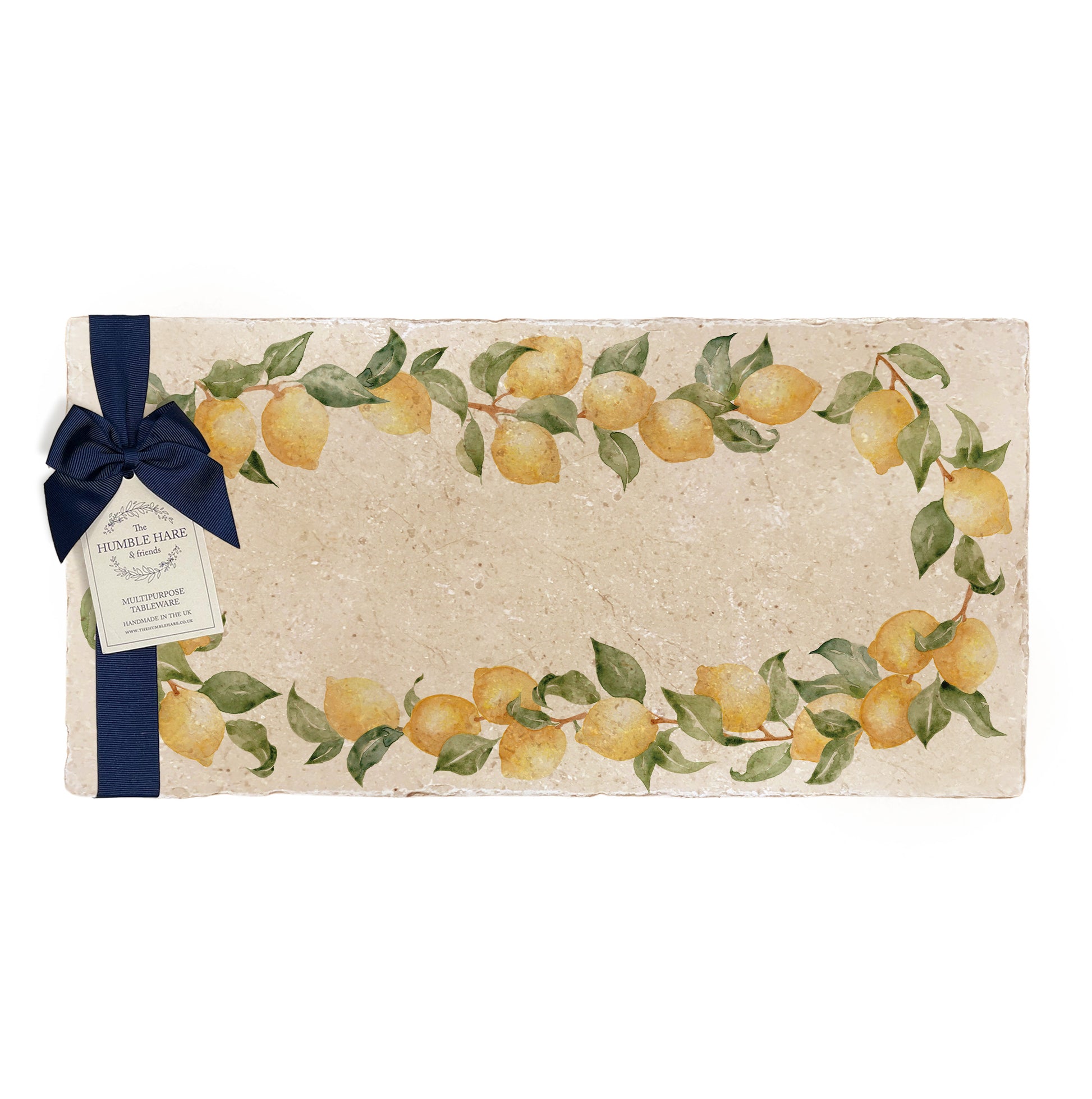 A multipurpose marble sharing platter with a watercolour lemon wreath design, packaged with a luxurious dark blue bow and branded gift tag.