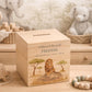 handmade wooden baby money box with watercolour animals in a nursery setting, This design features a majestic Lion sat on a rock in the Savannah. 