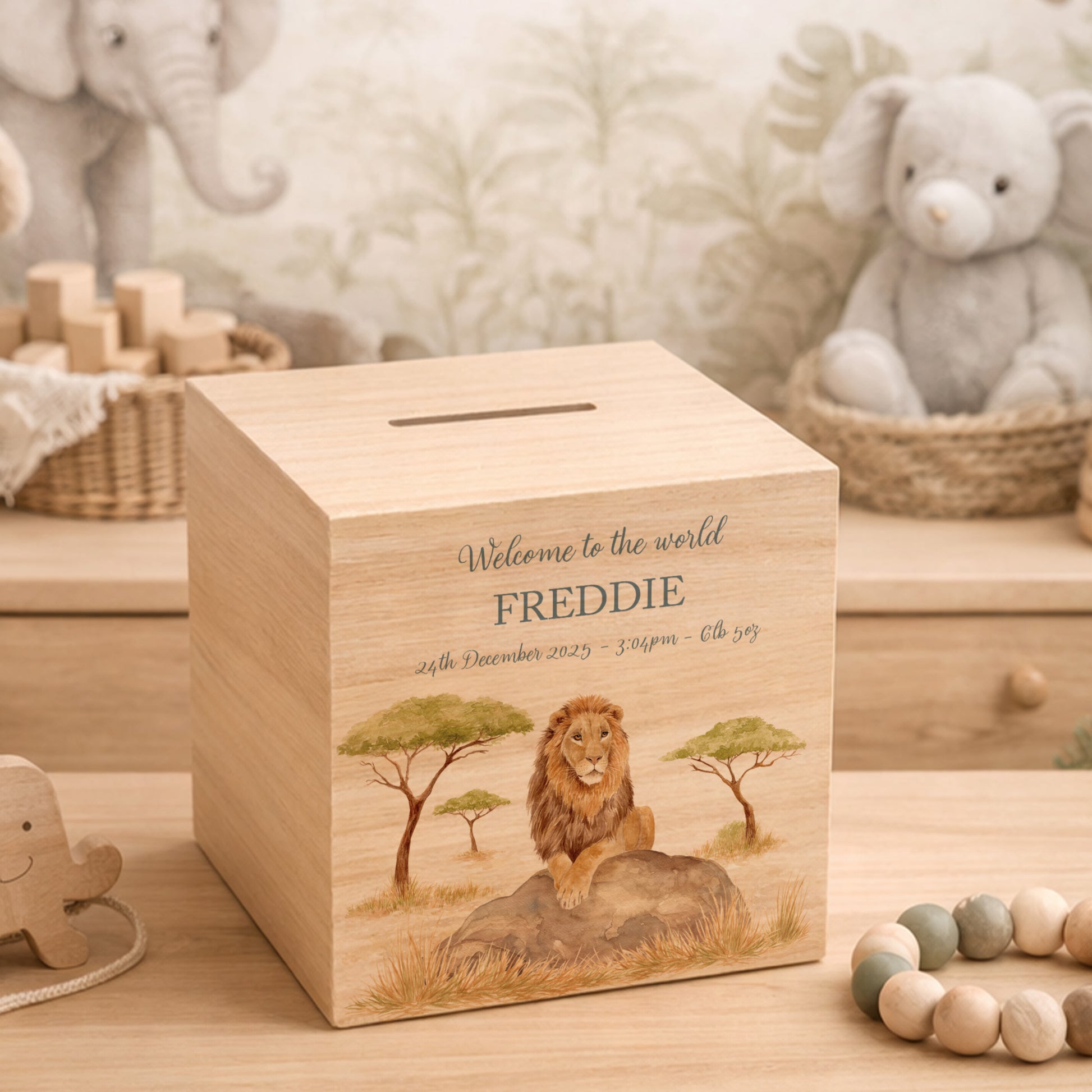handmade wooden baby money box with watercolour animals in a nursery setting, This design features a majestic Lion sat on a rock in the Savannah. 