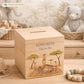 personalised handmade money box styled in nursery or childrens bedroom, This design features three happy meerkats sat on a rock. 