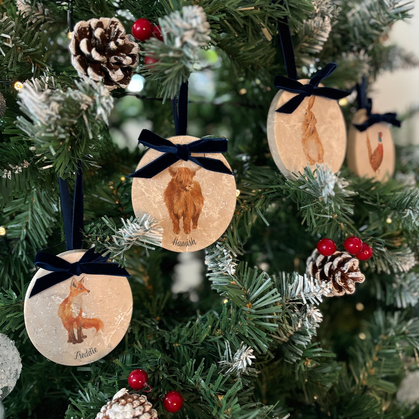 Handcrafted from marble, our oval-shaped bauble sets showcase beautiful watercolour artwork inspired by nature. Choose to add Christmas hats or not, and personalise each bauble with your own details. Finished with a velvet ribbon in various colours, they’re perfect for a bespoke holiday display.