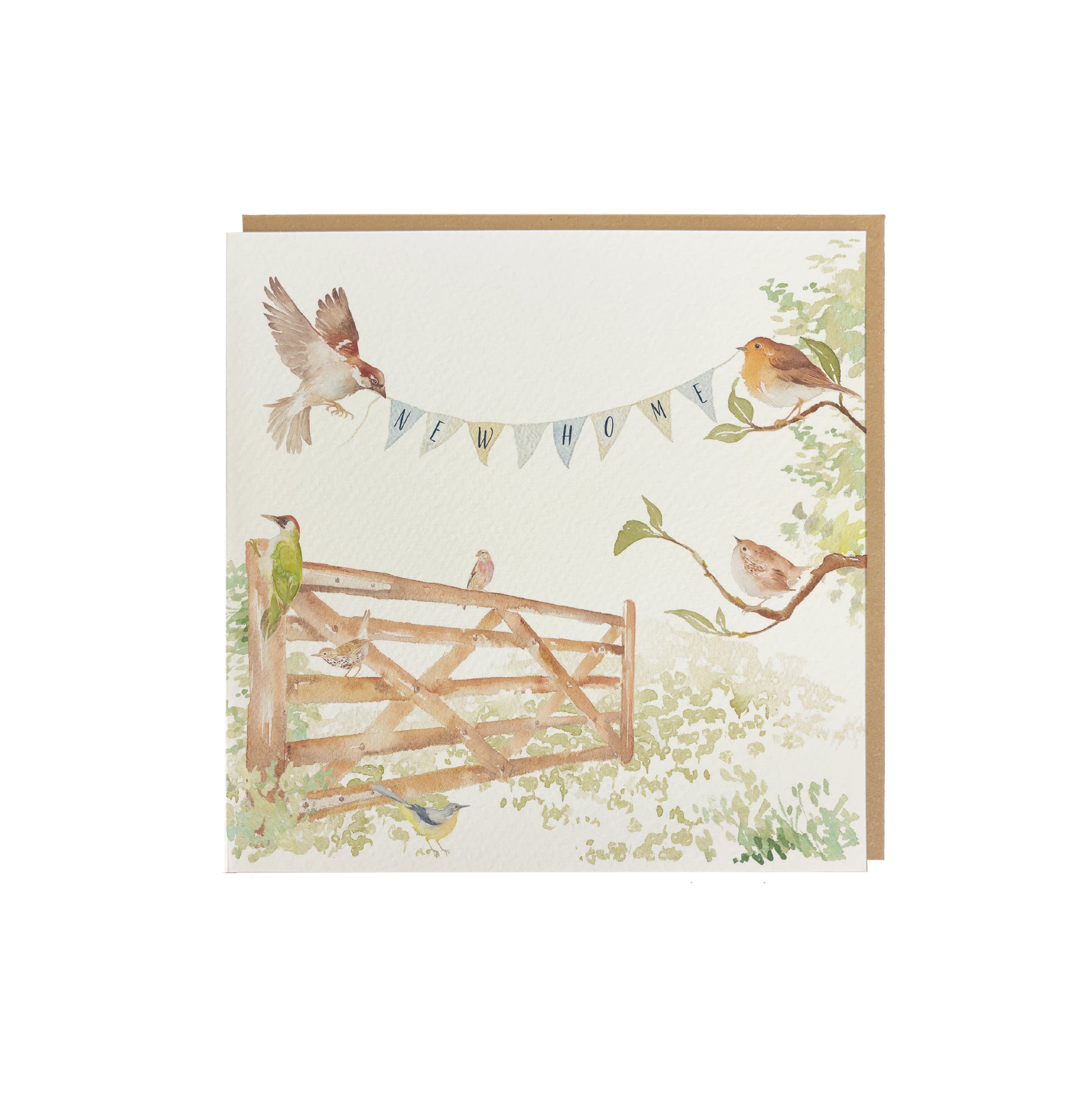 A greetings card reading New Home on bunting held by a sparrow and a robin above an open garden gate in a watercolour style. The card has a recyclable brown kraft envelope behind it.