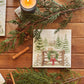 A square medium marble platter featuring a winter landscape watercolour illustration with snow-covered evergreen trees, a small cabin, mice playing on a wooden gate, a green wreath, and a red bow, 