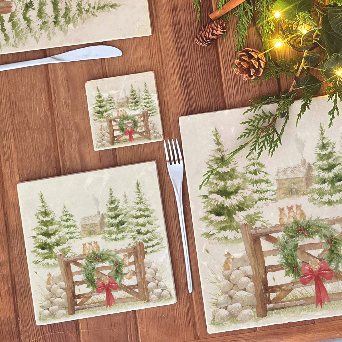 A square medium marble platter featuring a winter landscape watercolour illustration with snow-covered evergreen trees, a small cabin, mice playing on a wooden gate, a green wreath, and a red bow, 