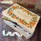 A beautiful Large Orange Wreath Charming wedding & Anniversary  keepsake box with custom names and delicate watercolour fruit artwork on a smooth pine wood finish. The perfect unique personalised gift box.