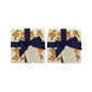 A set of 4 handmade marble coasters featuring a watercolour orange pattern, packaged in 2 pairs, with a luxurious blue bow and gift tag.