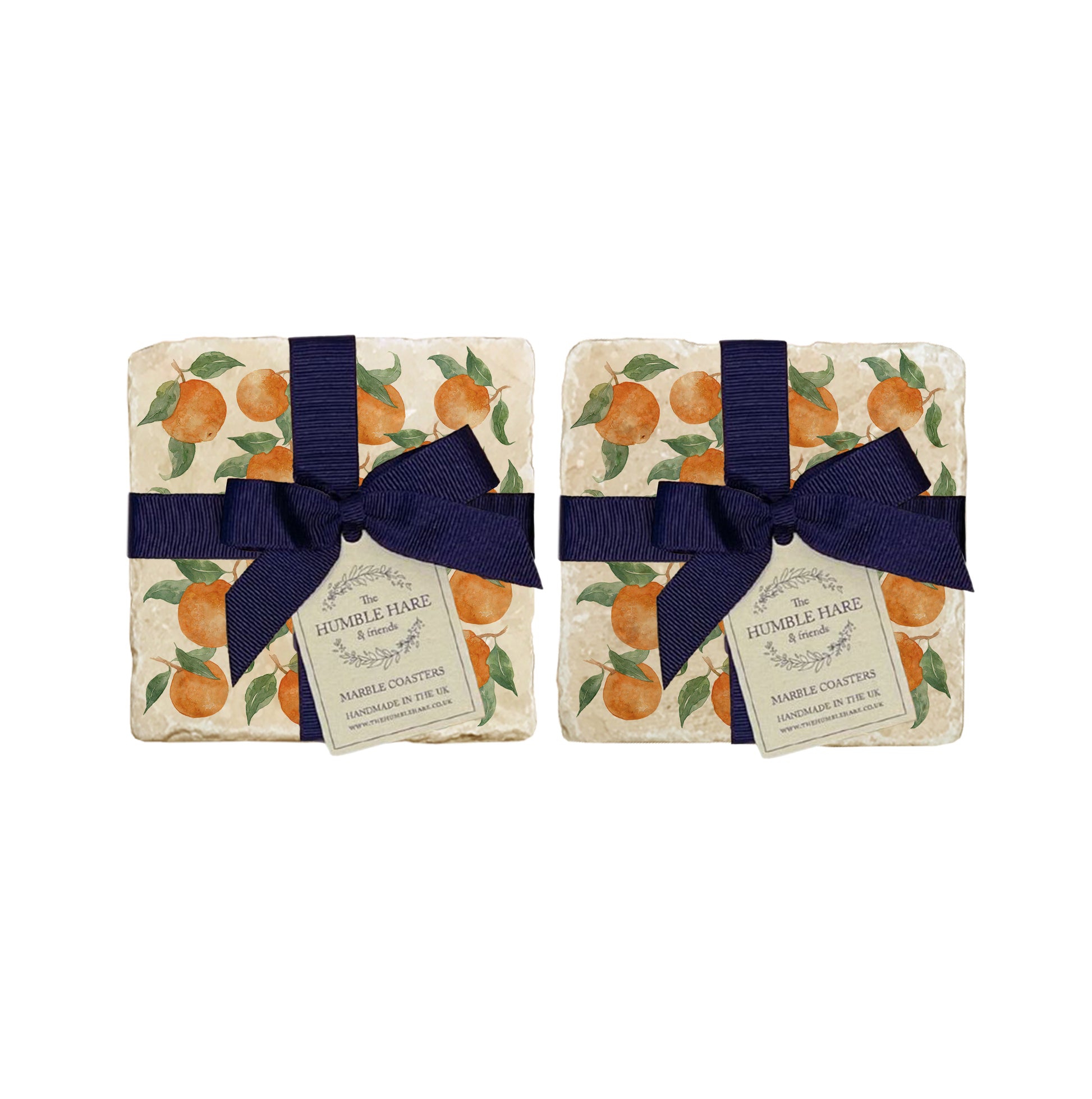 A set of 4 handmade marble coasters featuring a watercolour orange pattern, packaged in 2 pairs, with a luxurious blue bow and gift tag.