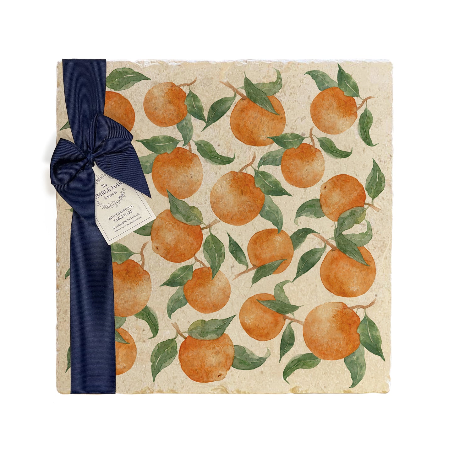 A large multipurpose marble platter with a watercolour orange pattern, packaged with a luxurious dark blue bow and branded gift tag.