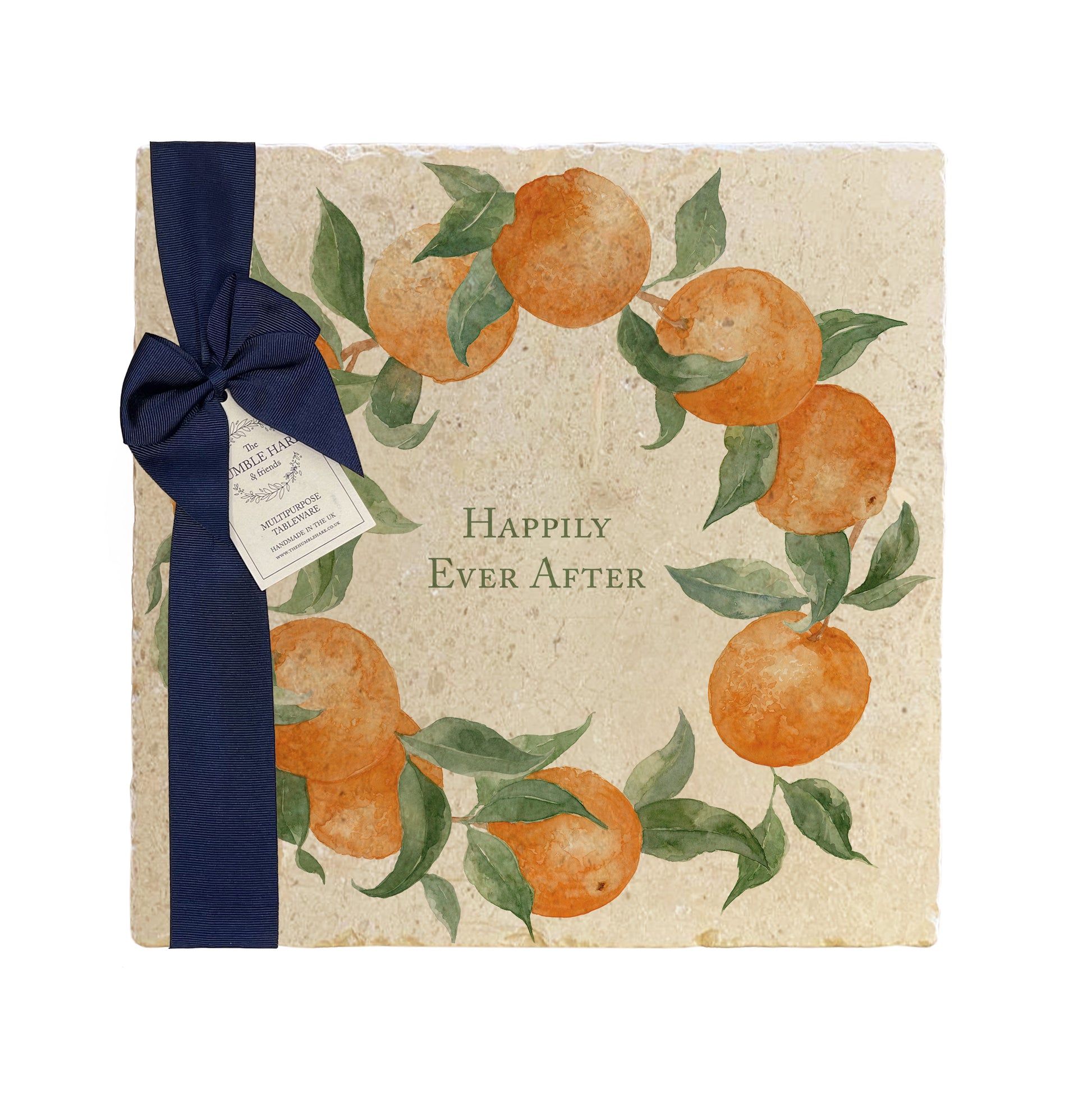 A personalised marble platter featuring a wreath of oranges and leaves, with a bespoke message in the centre of the design. The platter is packaged with a luxurious blue gift bow and tag.