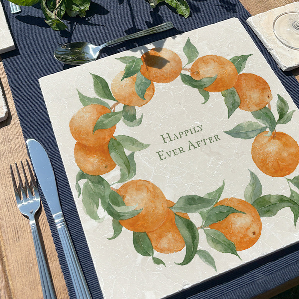 A large marble placemat personalised with the bespoke message 'Happily Ever After. The placemat is set on a table in a sunny garden.