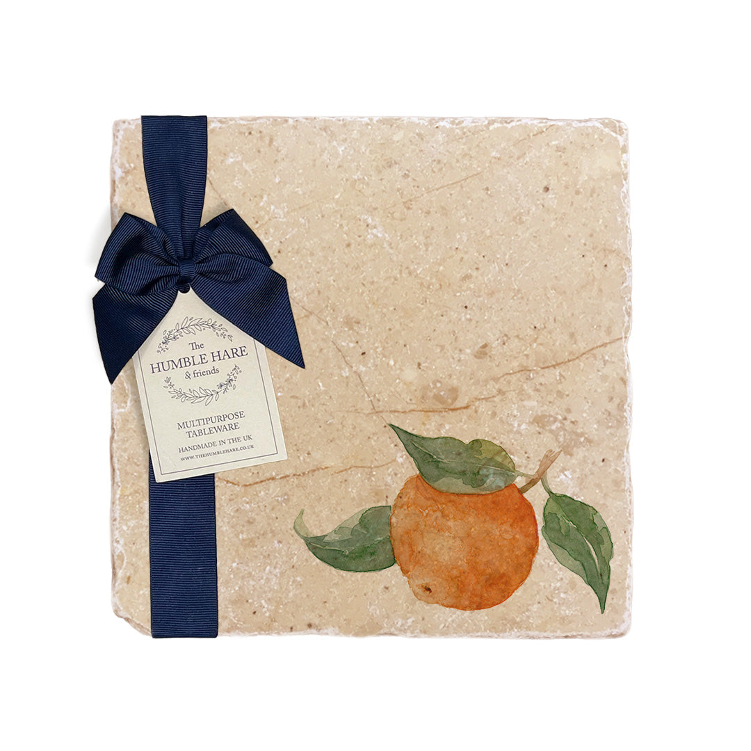 A medium multipurpose marble platter with a watercolour orange design, packaged with a luxurious dark blue bow and branded gift tag.