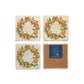 A set of 4 square marble coasters, featuring a watercolour orange branch wreath design. One coaster is flipped to show that the coasters are backed with cork.