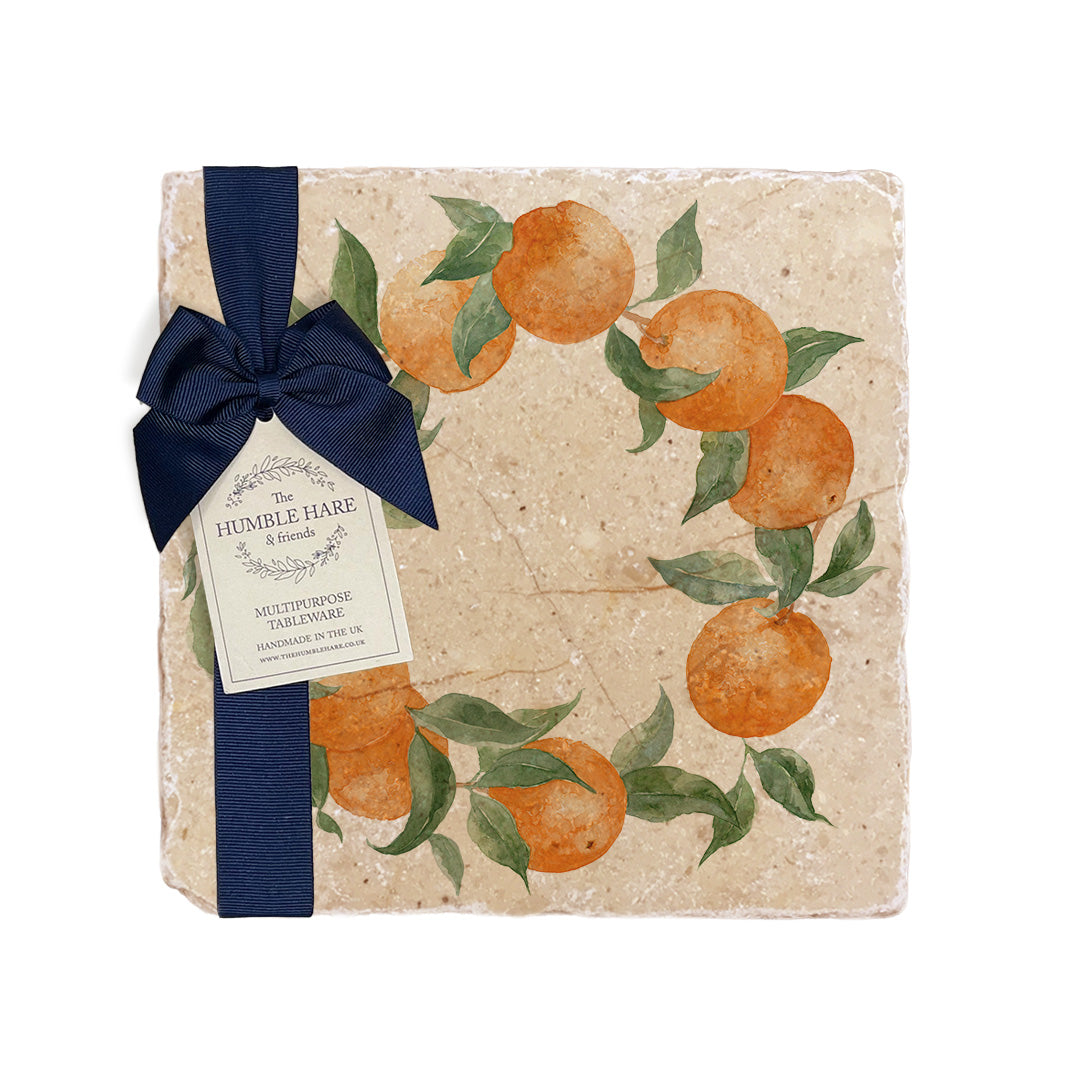 A medium multipurpose marble platter with a watercolour orange wreath design, packaged with a luxurious dark blue bow and branded gift tag.