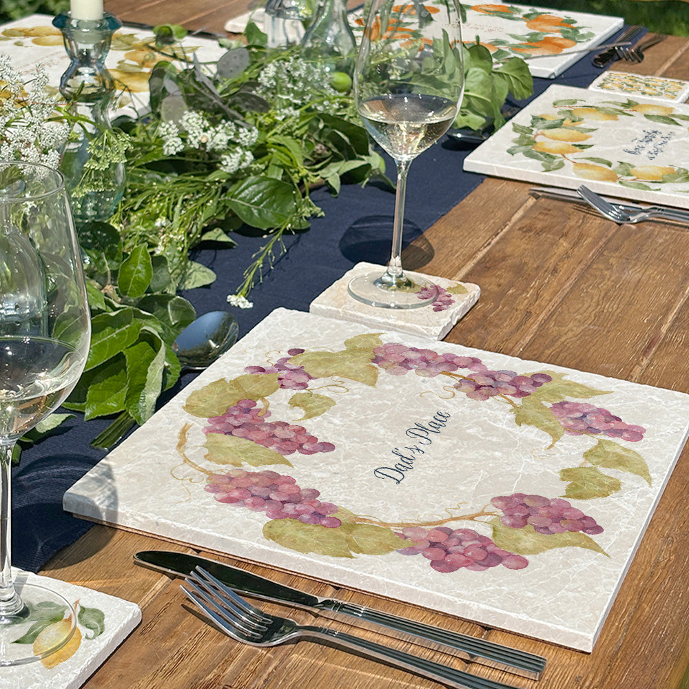 A beautiful garden table set with personalised marble placemats and coasters, ready for a dinner party.