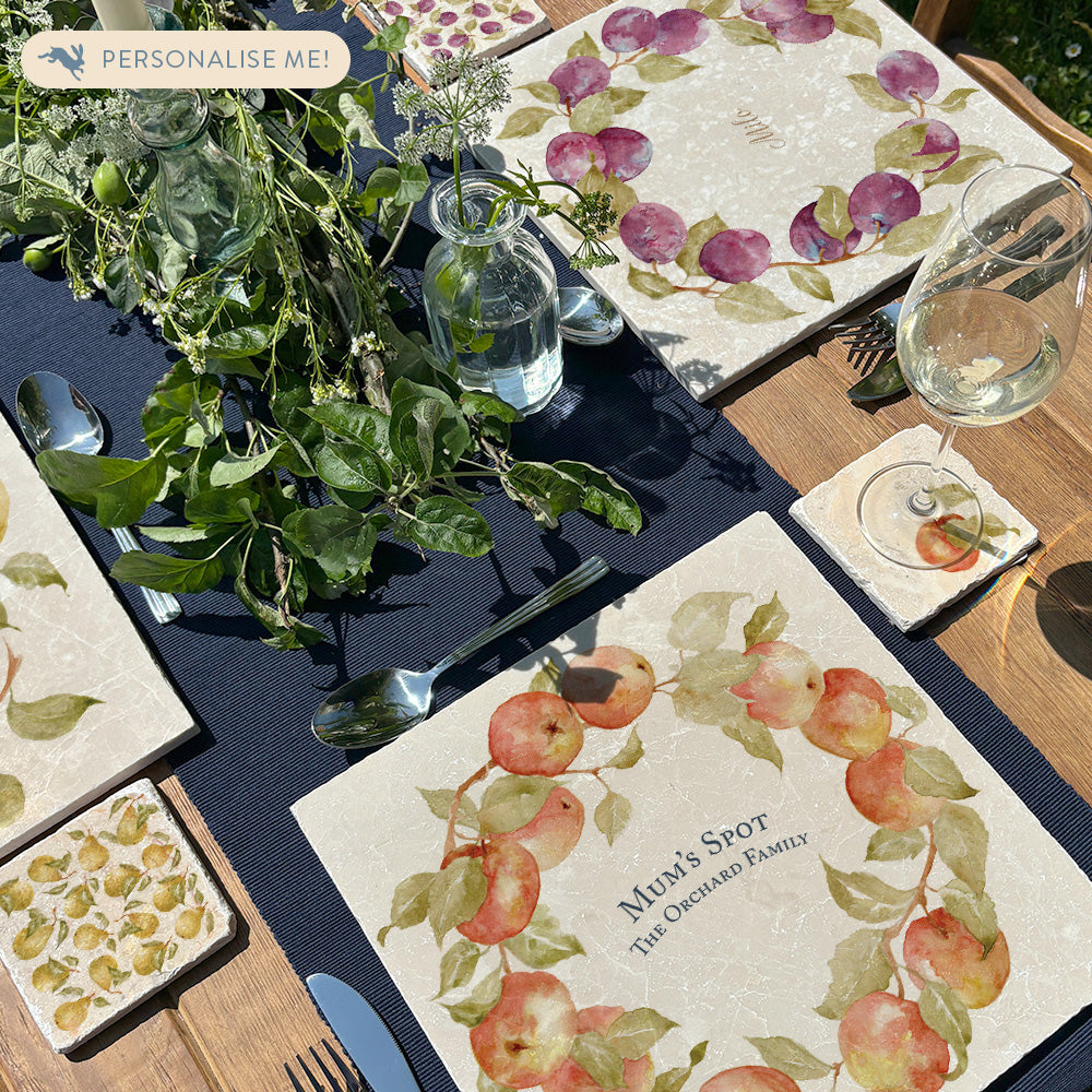 A beautiful garden table set with personalised marble placemats and coasters, ready for a dinner party.