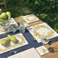 A medium square marble platter featuring a watercolour pear wreath design, set on an al fresco dining table with large and sharing marble platters in the matching watercolour pear design.