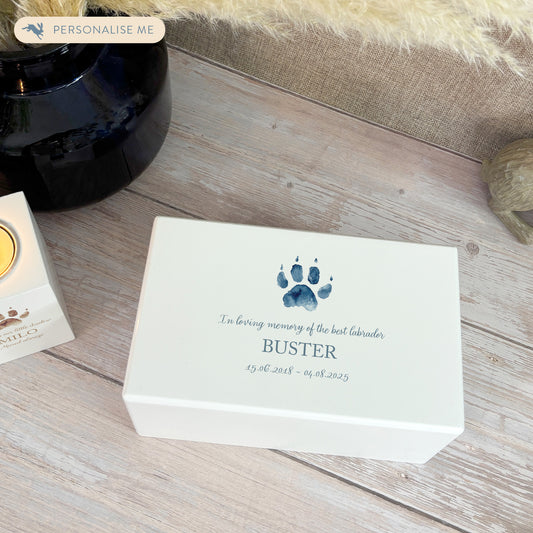 A beautifully crafted solid wooden urn, finished in white with a soft watercolour design of your cat or dogs paw print, Thoughtfully made for either display or burial, this personalised urn can be customised to create a meaningful memorial. Perfect for holding ashes of a beloved pet, it serves as a comforting tribute and keepsake.