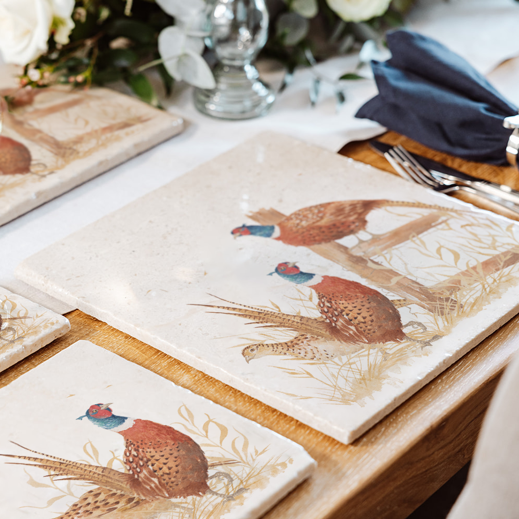 A beautiful dining set of marble platters and coasters featuring stunning countryside animals