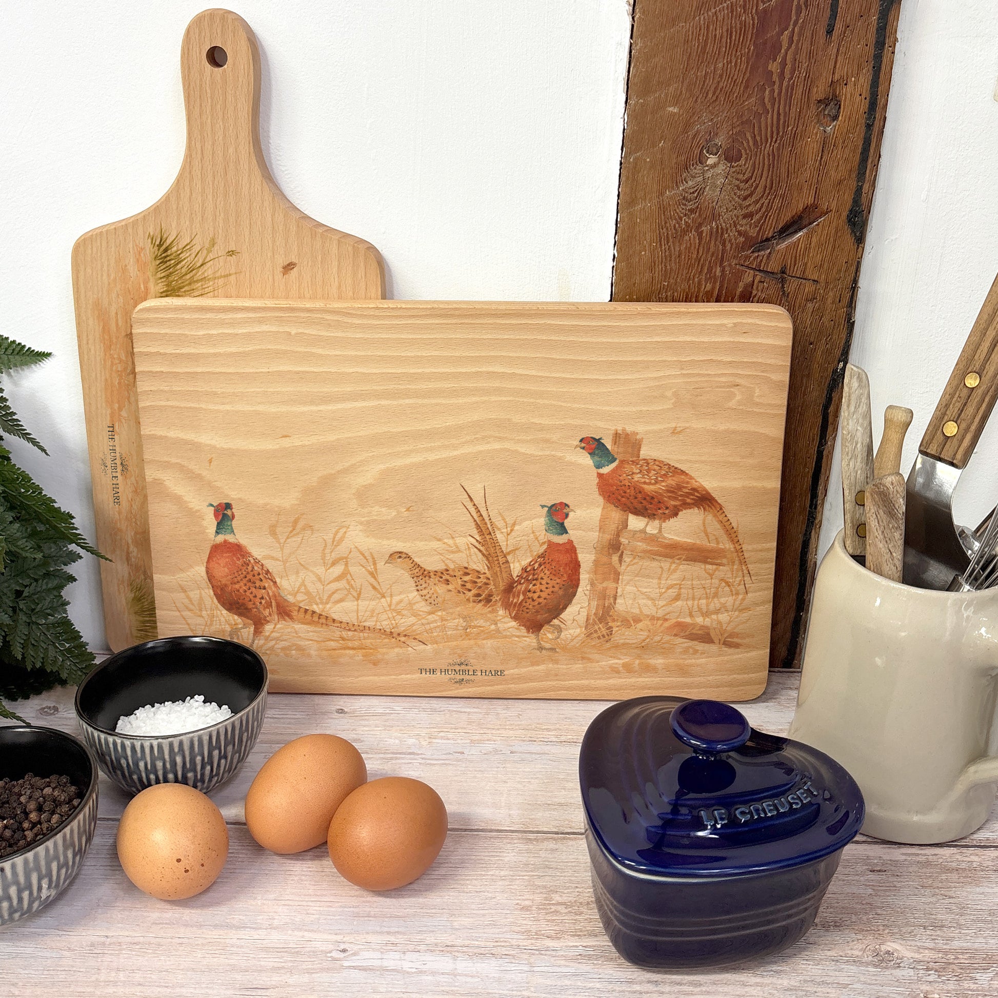 Three male pheasants and Lady pheasant taking shelter in the farmers field. perfect multipurpose chopping board 
