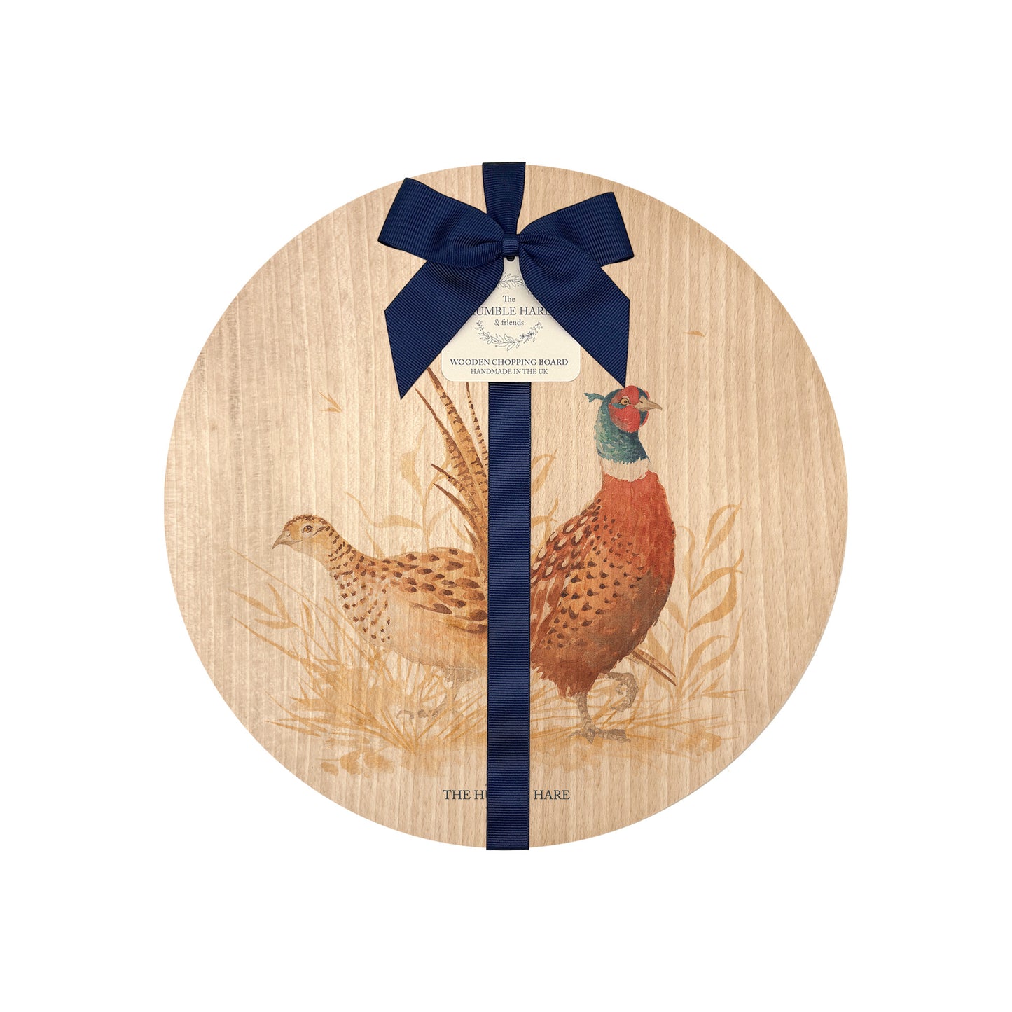 Round beech wood chopping board featuring a watercolour design of pheasants in the countryside. The wooden board is finished with a blue gift ribbon and tag.