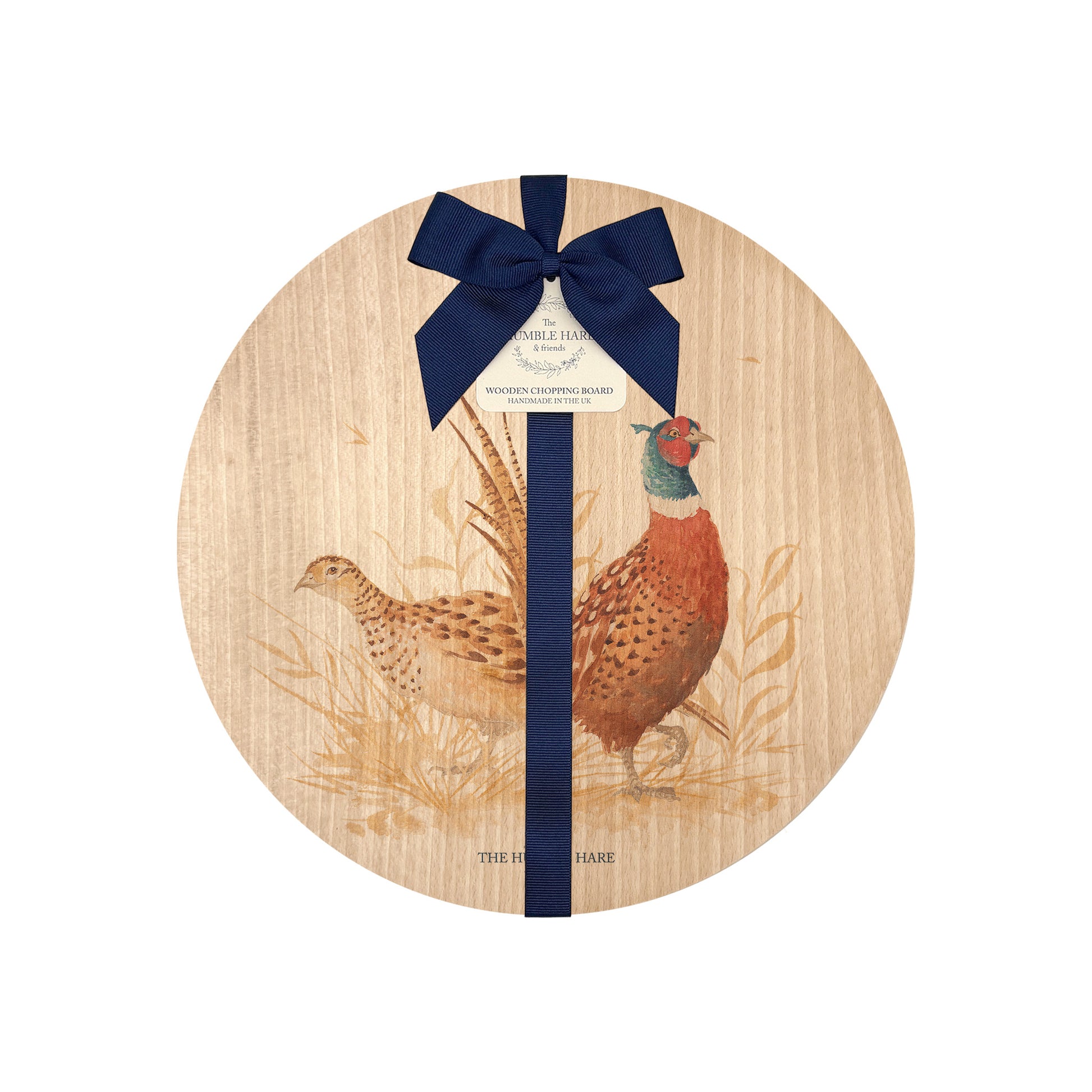 Round beech wood chopping board featuring a watercolour design of pheasants in the countryside. The wooden board is finished with a blue gift ribbon and tag.