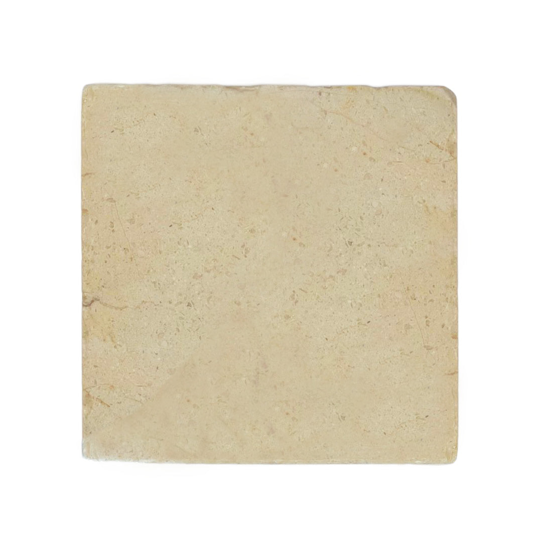 A plain medium square cream marble tile.