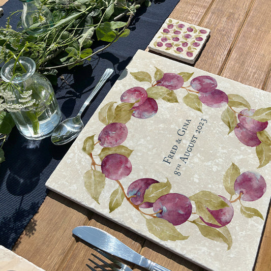 A large marble placemat personalised with a couple’s name and wedding date. The placemat is on a dining table set for entertaining.