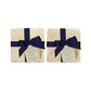 A set of 4 handmade marble coasters featuring a single watercolour plum, packaged in 2 pairs, with a luxurious blue bow and gift tag.