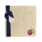 A large multipurpose marble platter with a watercolour plum design, packaged with a luxurious dark blue bow and branded gift tag.