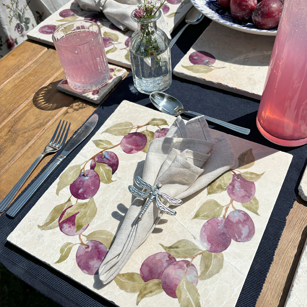 A large marble placemat featuring a watercolour plum wreath design. 