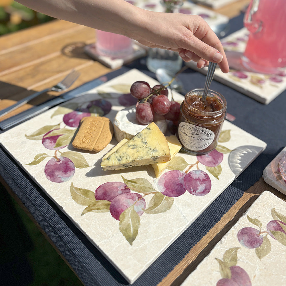 A large square marble cheeseboard featuring a watercolour plum wreath design.