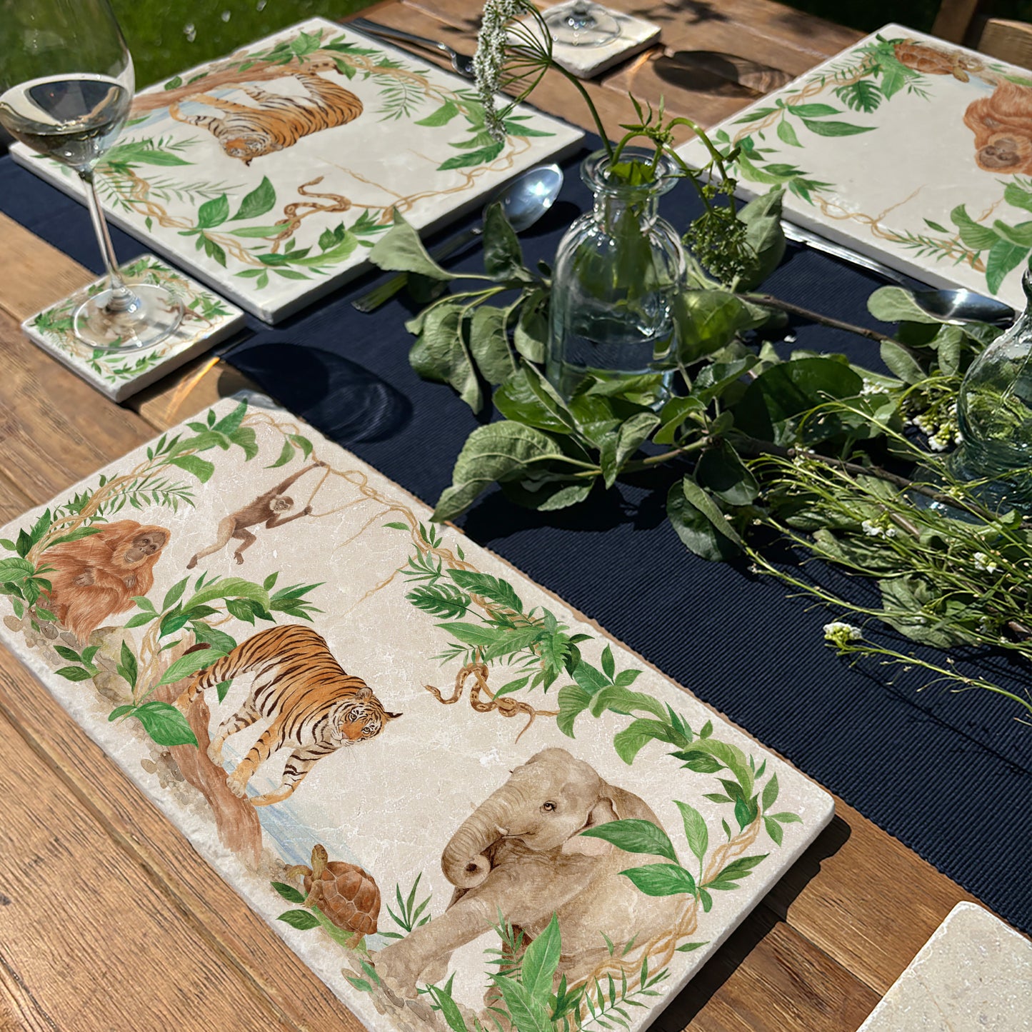 Welcoming our Rainforest Design, surrounded by the rainforest leaves and vines. Capture our Tiger and Python , Orangutan and Tortoise, Elephant and Gibbon quietly prowling through the Rainforest, Illustrated in our  original watercolour designs on Sharing Serving Large Placemat, Coaster and Medium worktop protector  Platter.