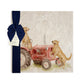 A square large marble platter featuring a watercolour design of working retriever dogs sat on a vintage red tractor. The platter is packaged with a luxurious blue gift bow.