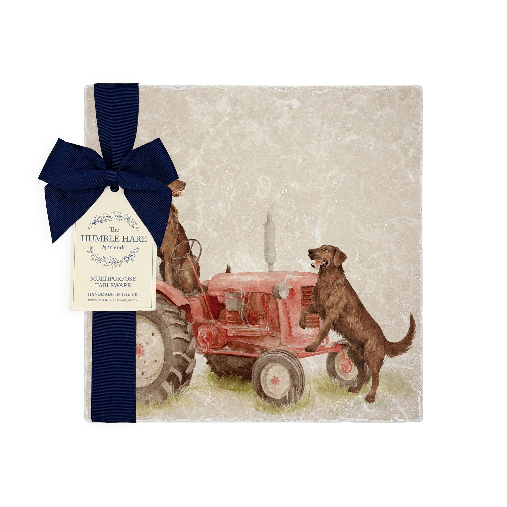 A square medium marble platter featuring a watercolour design of working retriever dogs sat on a vintage red tractor. The platter is packaged with a luxurious blue gift bow.