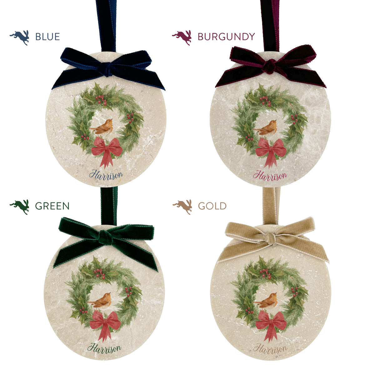 Four oval marble Christmas ornaments shown in colour options: blue, burgundy, green, and gold. Each ornament features a robin sitting on a Christmas wreath with a red bow, and a personalised name at the bottom, with a matching velvet ribbon bow.