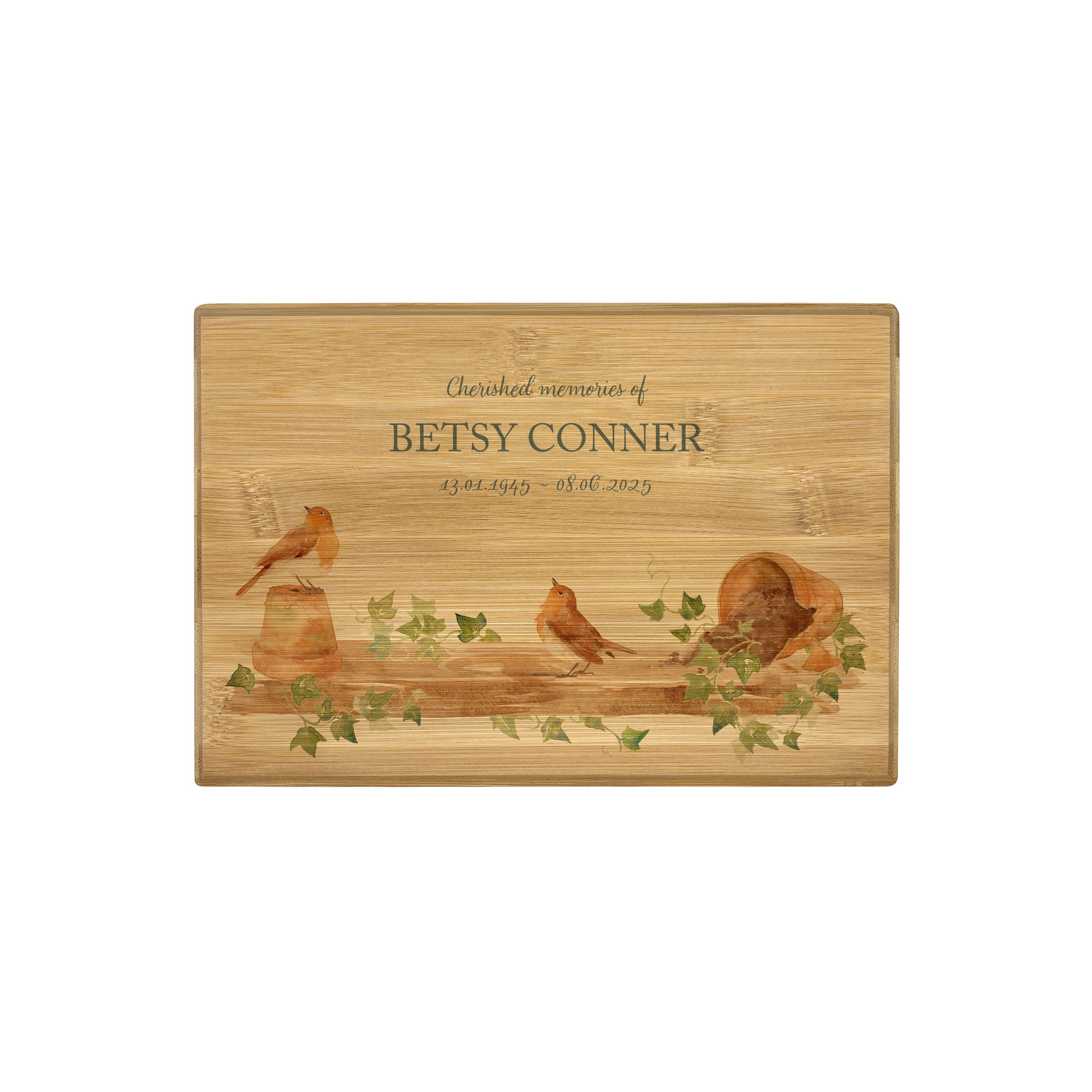 A beautifully crafted solid Bamboo wooden urn, personalised and finished with a soft watercolour design of Robins on a shelf sat on pots, when Robins appear a loved one is near. Thoughtfully made for either display or burial, this personalised urn can be customised to create a meaningful memorial. Perfect for holding ashes of a loved one or a beloved pet, it serves as a comforting tribute and keepsake. 