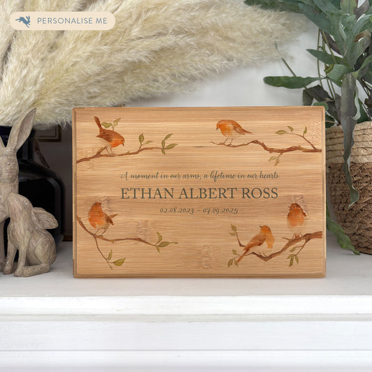 A beautifully crafted solid Bamboo wooden urn, personalised and finished with a soft watercolour design of Robins on branches, when Robins appear a loved one is near. Thoughtfully made for either display or burial, this personalised urn can be customised to create a meaningful memorial. Perfect for holding ashes of a loved one or a beloved pet, it serves as a comforting tribute and keepsake. 